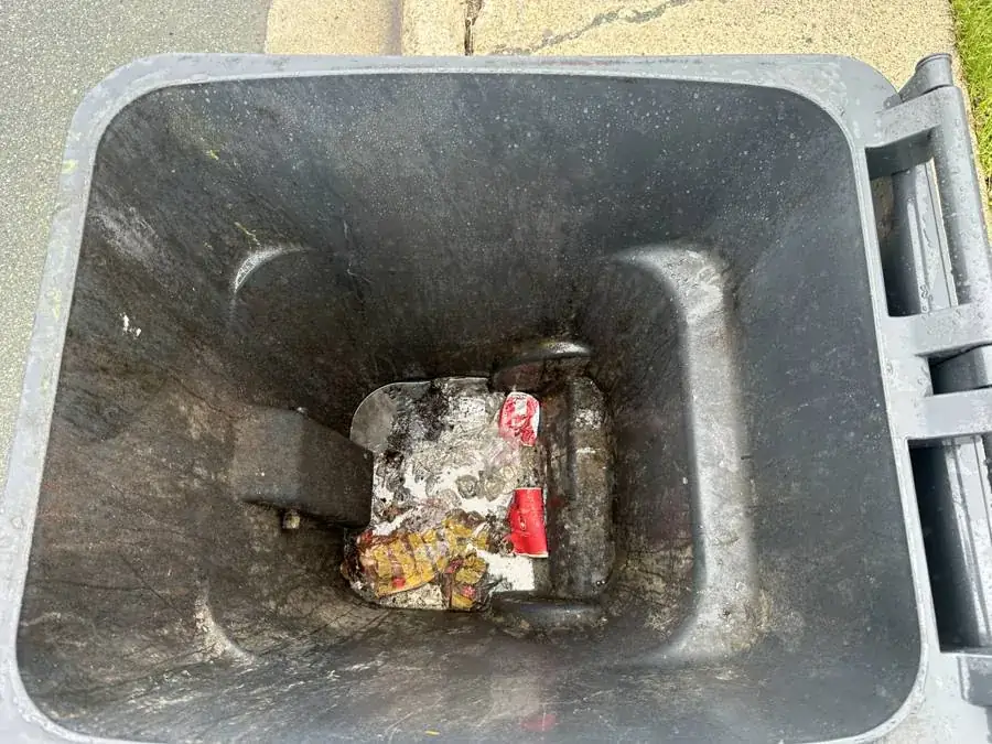 A dirty garbage bin before cleaning — grime and stuck-on waste